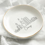 A white ceramic Skyline Jewelry Dish featuring a minimalist Chicago skyline sketch and elegant gold trim, perfect for organizing daily rings and trinkets.
