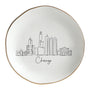 A white ceramic Skyline Jewelry Dish featuring a minimalist Chiccago City skyline sketch and elegant gold trim, perfect for organizing daily accessories.