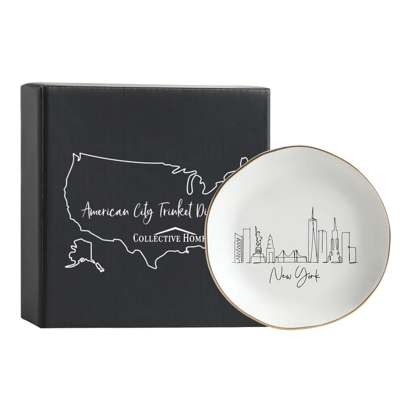 A white ceramic Skyline-Jewelry-Dish-New-York with elegant gold trim, presented in a branded Collective Home gift box, perfect as a sophisticated gift for jewelry organization.