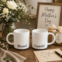 Thoughtful Mother’s Day gift set featuring 'Blessed' and 'Grateful' ceramic coffee mugs in an elegant black gift box, held in a cozy home setting with fresh flowers.